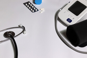 Medical device and medicine with a white background. Blood pressure monitor Heart disease diagnosis...
