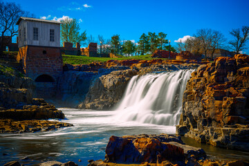 Sioux Falls City Spring Landscape at the Falls Park in Sioux Falls, South Dakota, USA, silky water falling over quartzite and pipestone rock formations in the Big Sioux River