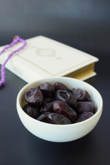 Holy book Quran and rosary on table, close up.