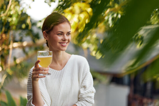 A Woman Enjoying a Healthy Breakfast Outdoors Fresh and vibrant, this image showcases a young woman immersed in nature, savoring a glass of refreshing kombucha infused with antioxidantrich fruits