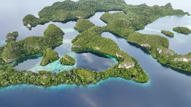Early morning light illuminates the beautiful limestone islands of Pef in Raja Ampat, Indonesia. This remote, tropical region is known to harbor the world's greatest marine biodiversity.