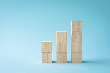Wood cube stacking as step stair. On blue color background. Success or career ladder concept.