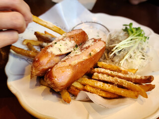 Potato fries and sausages on a plate