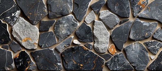 Rocks of various sizes create a textured surface on a close up of a sturdy stone wall