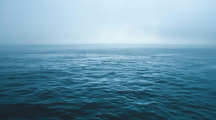 Obraz premium Serene ocean view under a muted sky, conveying the echoing silence of nature, vast waters reflecting the stillness and solitude