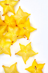 star fruit slices scattered on white, with copy space