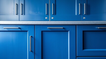 A market-style showcase of blue kitchen cabinet doors, adorned with contemporary stainless steel handles