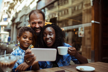 Family Taking a Selfie at a Cafe Terrace