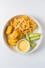 chicken nuggets with french fries and sauce