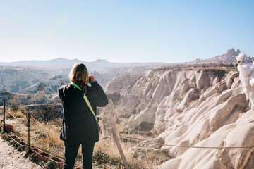 Rear view of Woman Standing Alone Enjoying Mountain Scenic View