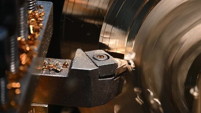 Closeup scene the lathe machine finish cut the brass parts by lathe tools.