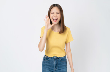 Young asian woman shouting and hands over mouth on white background studio.