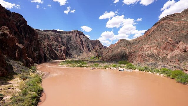 view from the middle of Black South Kaibab suspension bridge over the muddy Colorado River where river rafting occurs in the Grand Canyon