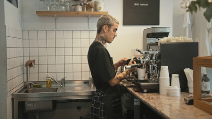Handsome barista guy work coffee shop. Tattooed hipster man. Male face smile. Joy young adult...