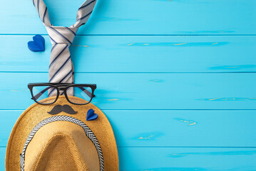 Create the ambiance for Dad's special day! Top view image of a straw hat, sleek tie, glasses, fake...