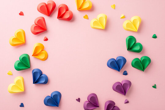 Unity in diversity: Colorful hearts on pastel pink background, echoing solidarity. Capturing the essence of Pride month, leaving empty circle with space for impactful social messages or advertisements