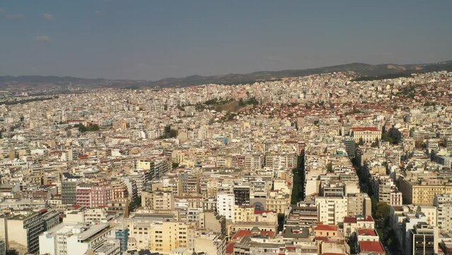 Drone footage of the cityscape view of Thessaloniki city in Greece on a sunny bright day