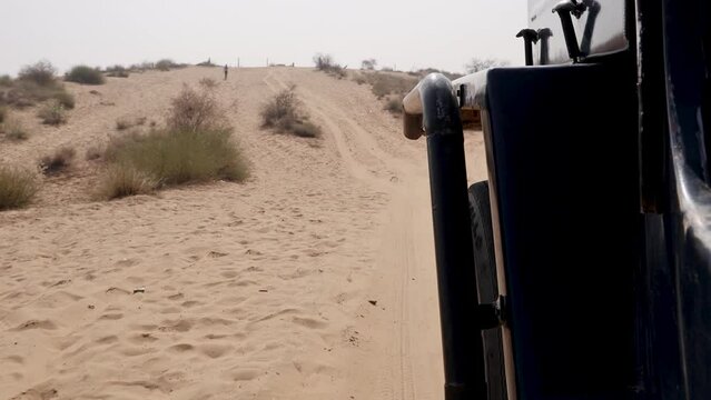 san dunes safari and offloading by motorcar at deserts at day from different angle video is taken at rajasthan, India.