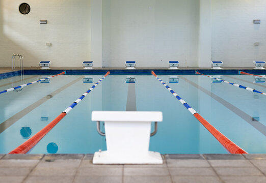 Swimmers are not present in the indoor pool with lanes marked for racing