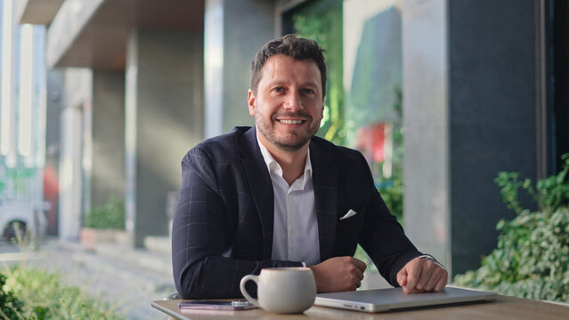 Handsome 30s top manager work laptop. Entrepreneur type computer macbook. Business man look monitor. Young male businessman. Urban city background. 40s employee create start up. Ceo office boss job.