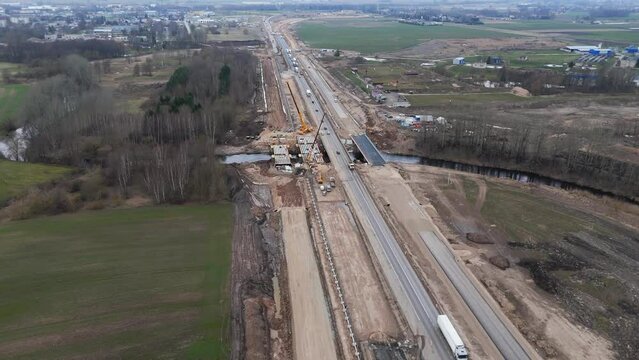 Aerial shot of the road under construction for the expansion project, there is a construction site with the equipment for work.
