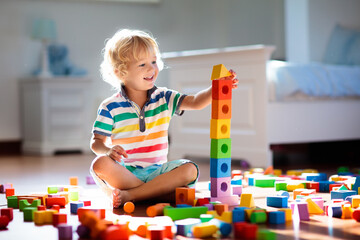 Child playing with colorful toy blocks. Kids play. - obrazy, fototapety, plakaty