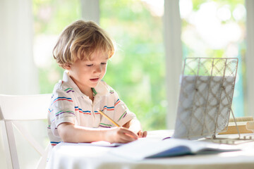Online remote learning. School kid doing homework. - 793604920