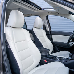 Leather interior design, car passenger and driver seats, clean, wide angle view, white perforated...