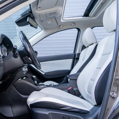 Leather interior design, car passenger and driver seats, clean, wide angle view, white perforated leather