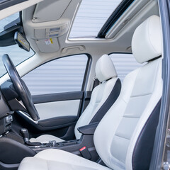 Leather interior design, car passenger and driver seats, clean, wide angle view, white perforated leather