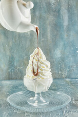 Liquid chocolate paint drizzled over whipped cream like a feather painting