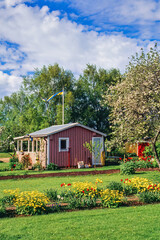 Pink cottage on an allotment garden a sunny summer day. - 793611900