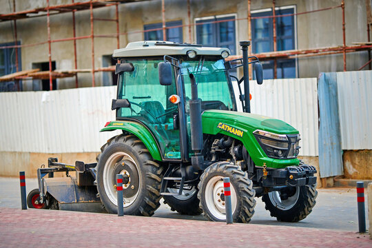 Minsk, Belarus. Oct 16, 2022. Small tractor CATMANN with sweeper brush parked at city street. Cleaning machine, tractor with rotary brush to sweep road, sidewalk on construction site. Selective focus