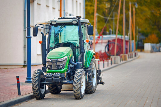 Minsk, Belarus. Oct 16, 2022. Small tractor CATMANN with sweeper brush parked at city street. Cleaning machine, tractor with rotary brush to sweep road, sidewalk on construction site. Selective focus