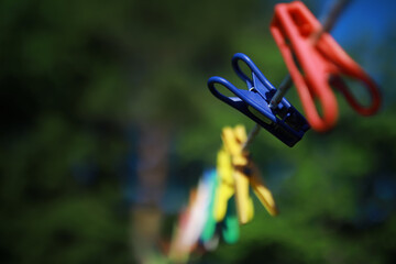 old pegs on a rope. One old retro clothespin wooden on a linen rope. Work on the house, washing,...