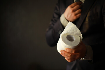 Rich Businessman paying in Toilet Paper, copy space. Toilet papers is the new currency