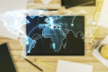 Abstract graphic digital world map with connections and modern digital tablet on desktop on background, top view, globalization concept. Multiexposure