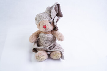 A stuffed bunny toy in a bath towel on its head