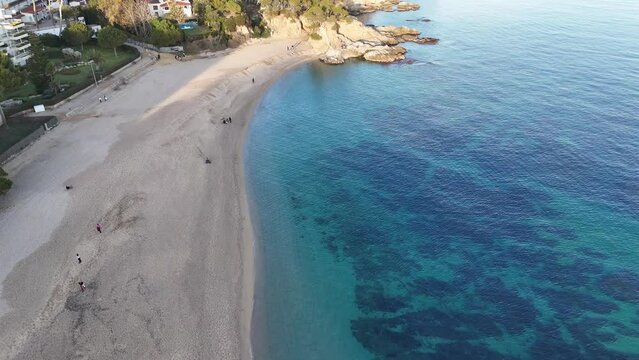 Drone footage over the beach in the coast of Platja dAro with serene sea view in Girona, Spain