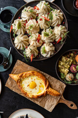 Golden-crusted Adjarian khachapuri teamed with succulent, spice-infused khinkali, assorted phali. A feast of Georgian delights, rich and alluring.