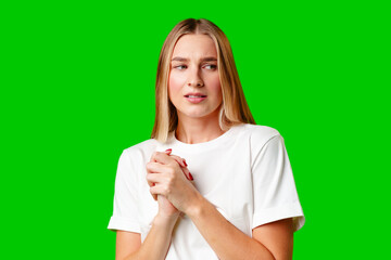 Young Woman With Pursed Lips Expressing Skepticism Against Green Screen Background