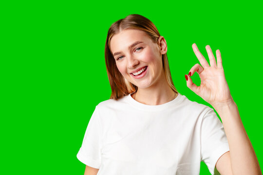 Young Woman Giving Thumbs Up Sign on Green Screen
