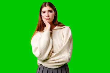 Young Woman Looking Bored and Disinterested Against Green Background