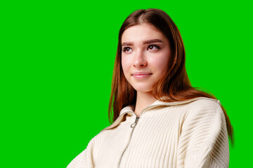 Young Woman Posing in Stylish Crop Hoodie and Pleated Skirt Against Green Screen