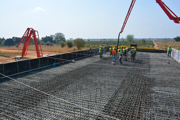 Two Concrete Pumps Pouring Foundation for Building Construction