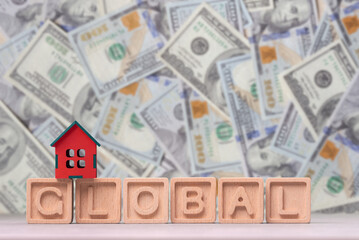 A house is on top of a stack of wooden blocks that spell out the word Global