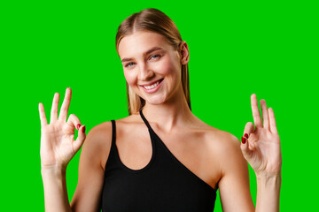 Young Woman Giving Thumbs Up Sign on Green Screen