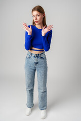 Young Woman in Blue Top Holding Out Hands