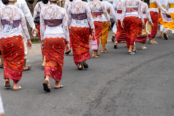 Balinese traditional wear while attending ceremonial event