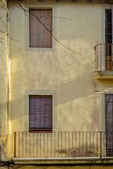 Facade of a house with wooden shutters in the village of Moia (Spain)